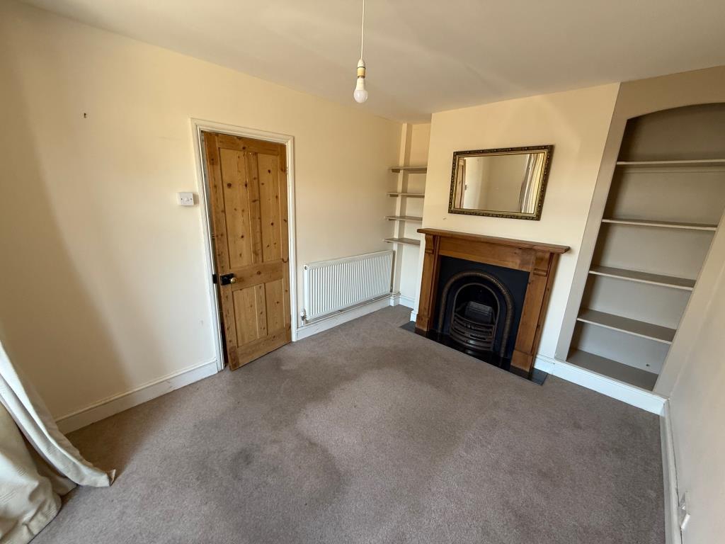 Lot: 116 - END-TERRACE HOUSE WITH PARKING - Living room with bay window and feature fireplace